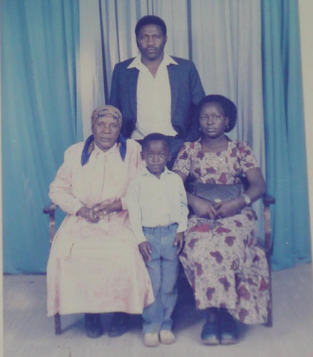 Photo of my grandmother and mother (seated), my father and I (standing) in 1987 at Ramogi Studio, Nairobi